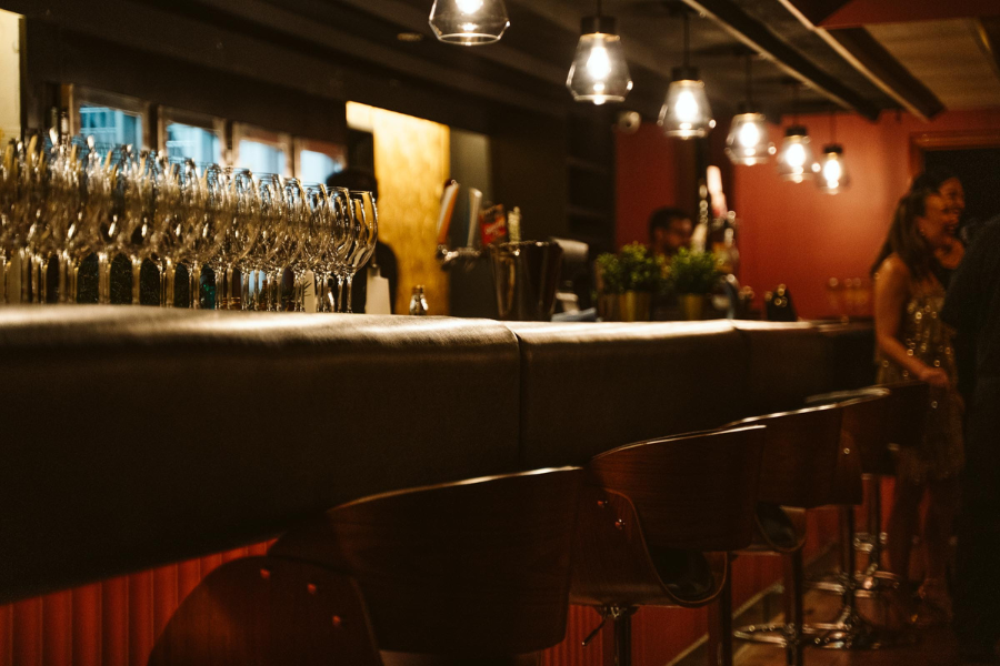 Rows of champagne flutes along the bar as guests arrive